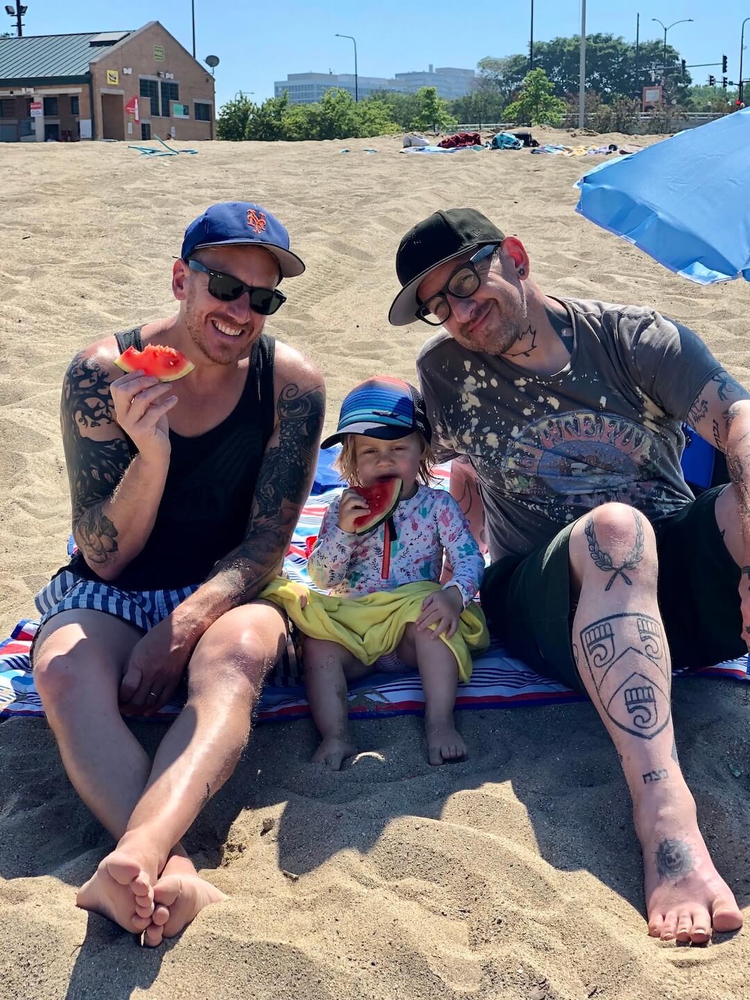 Chef Aram, Sloan, and Eden sitting on the beach